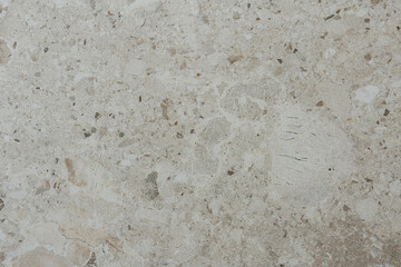 Obraz premium Beige granular stone surface displaying natural abstract texture