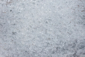 Fototapeta premium Texture of a frozen lake of ice, top view from a drone.