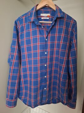 Blue and Red Plaid Button Up Shirt Hanging on Neutral Background