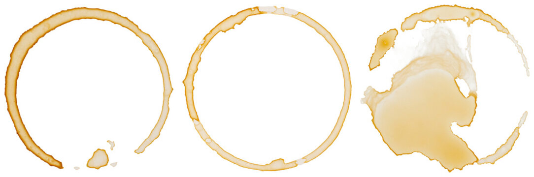 Three distinct coffee cup rings and splatters, a realistic photograph isolated on a transparent background for design.