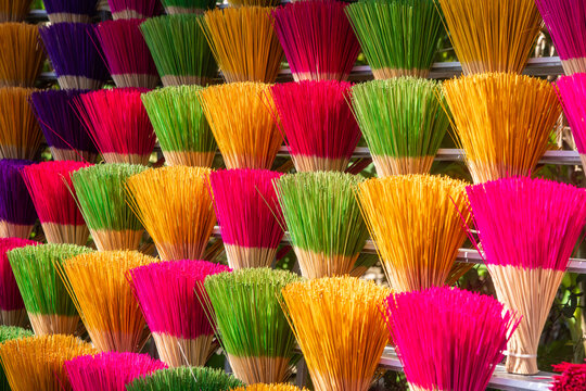 View of vibrant bundles of incense sticks burst in a spectrum of colors, creating a mesmerizing display of texture and artistry, Hue, Vietnam.