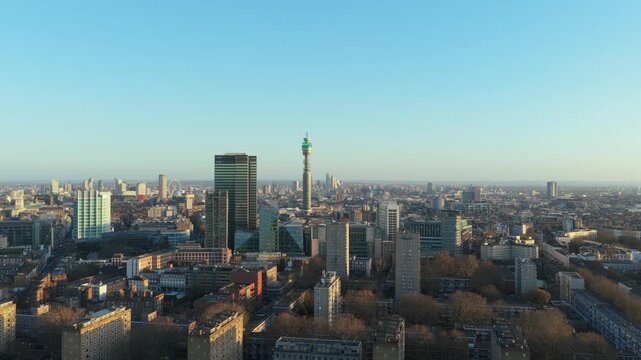 Aerial panorama of London with iconic BT Tower, residential buildings, and modern skyscrapers under a clear sky, showcasing urban landscape of Euston and Warren Street