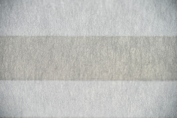 Fototapeta premium Close-up of the white textile fibers of a folded sun visor with a shallow depth of field