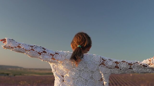 Child lavender field summer girl spinning happily in a stunning purple field wearing heart sunglasses and white crochet shawl at sunset.