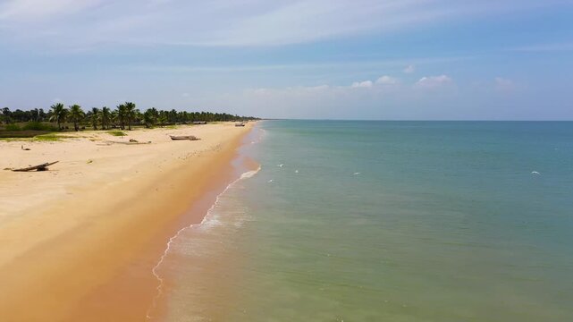 Travel concept: flying over a beautiful sandy beach and a blue ocean. Sri Lanka.