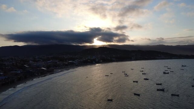 Sunset over a fishing town, drone up