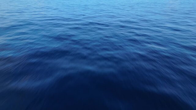 Aerial drone view of rippling Caribbean ocean surface with deep blue water and natural wave patterns