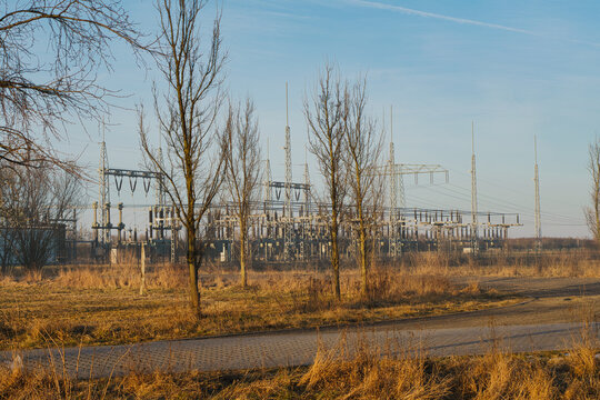 A Large Electrical Substation Infrastructure Amidst Winter Trees and Fields