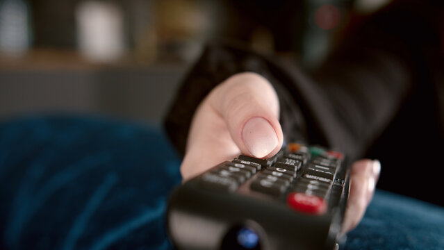 Person Holding Remote Control Pointing at Camera, have fun and enjoy