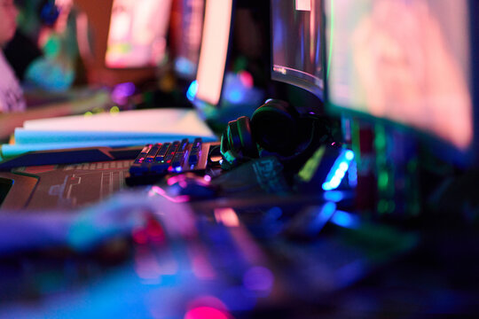 Colorful RGB PC Gaming Setup With Mechanical Keyboard And Headset At Nighttime LAN Party