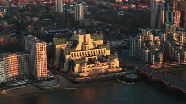 Golden hour illuminating MI6 Building on River Thames with Vauxhall Bridge and London Borough of Lambeth revealing city's unique architecture