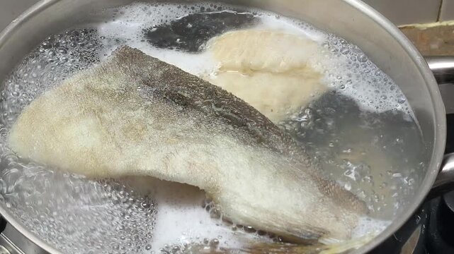 boiling cod fish in iron pot