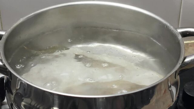 boiling cod fish in iron pot