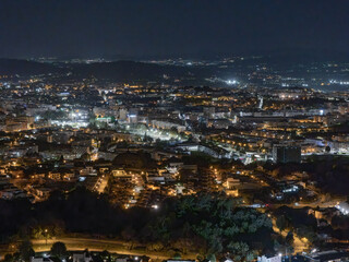 Fototapeta premium Night aerial view of Braga city lights and urban architecture, Minho region, Portugal
