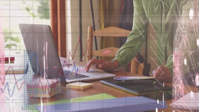 Animation of financial data processing over african american businessman using laptop in office