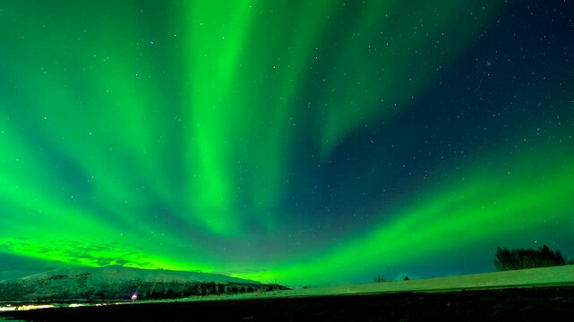Magical aurora borealis timelapse of green dancing light in starry night sky