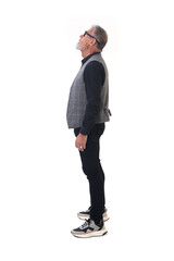 Fototapeta premium side view of a modern retired man standing looking up on white background