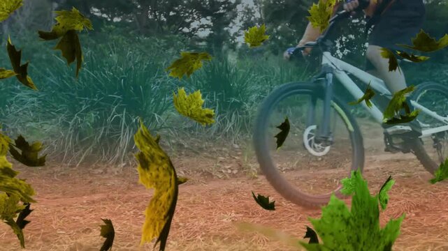 Animation of green leaves falling over caucasian man riding mountain bike in forest