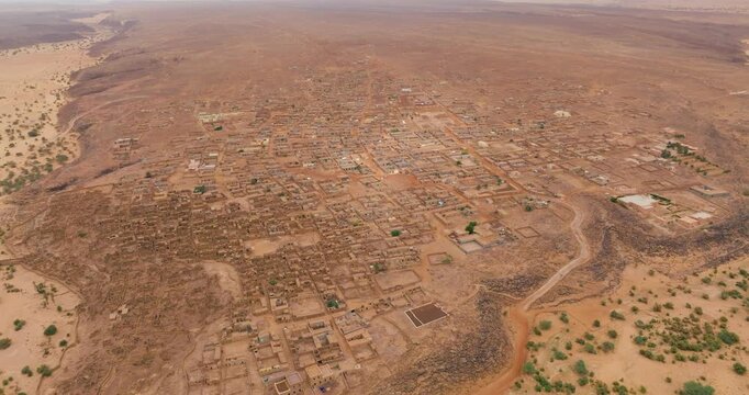 View From Above Of Ancient Fortified Town Of Ouadane In Sahara Desert's Adrar Plateau, Mauritania. aerial tilt-down shot