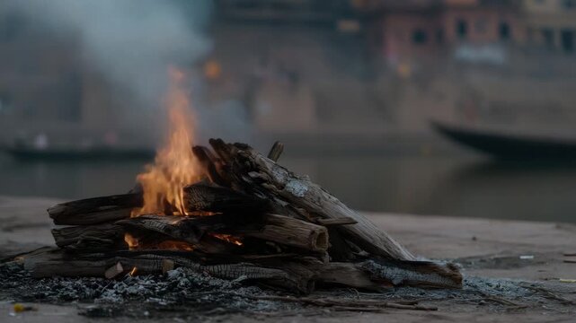 Traditional cremation fire with rising smoke, funeral ritual, sacred ceremony, cultural tradition, spiritual farewell, glowing embers, solemn atmosphere