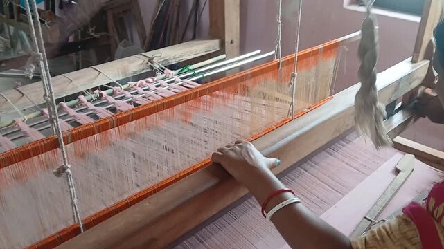 Handloom weaver in India working in her loom.	