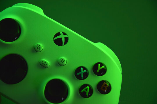 The white Xbox controller with green light.