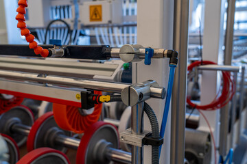 Fototapeta premium Automated production line conveyor system with rollers and pneumatic controls.