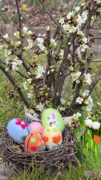 easter nest with colorful felted easter eggs on a green meadow	

