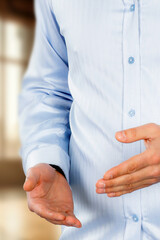 Businessman standing with his arms against neutral background. The composition highlights confidence, professionalism and modern business lifestyle.