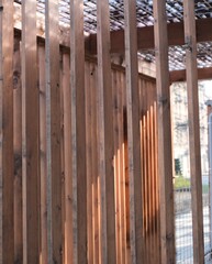 Obraz premium Wooden vertical slats with light and shadow pattern, minimal architectural background