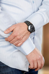 Businessman standing with his arms against neutral background. The composition highlights confidence, professionalism and modern business lifestyle.