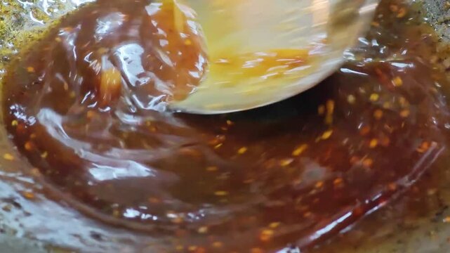 Homemade Pad Thai sauce with tamarind paste and palm sugar simmering in a hot wok.