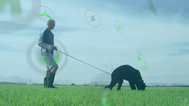 Man walking dog across green field, showcasing environmental technology with floating energy icons
