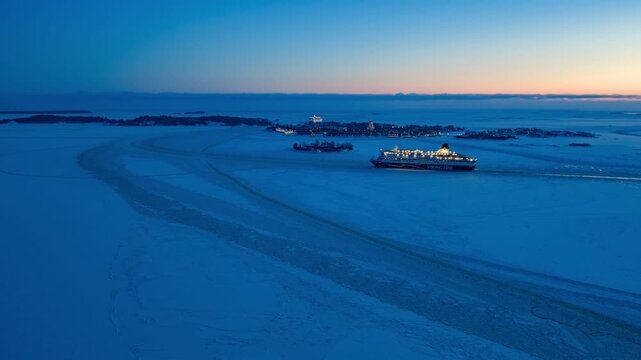 Aerial hyperlapse of ferries passing Suomenlinna Sea Fortress. Helsinki winter evening.