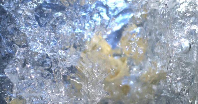 Cooking tortellini in boiling water at home in the kitchen during the evening