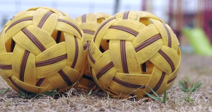 Sepak takraw balls are used for training on the ground.
