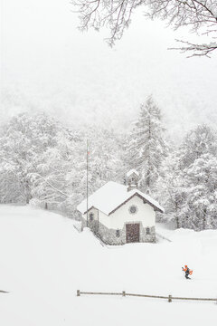 hiker passes through the mountain village, Alpe Cainallo, Lombardy landscape