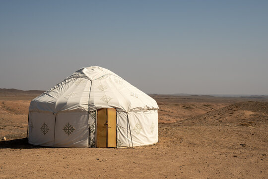 White felt yurts in the picturesque spring landscape of Central Asia. Traditional nomadic dwellings in the steppe