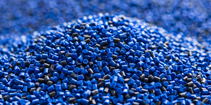 Close-up Macro View of Blue and Black Plastic Granules and Polymer Pellets Used for Industrial Manufacturing, Recycling Processes, and Production of Synthetic Raw Materials in Bulk