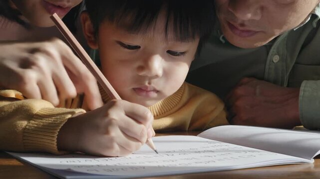 Child writing or drawing in a notebook while parents lean close, highlighting learning, guidance, and supportive family education moment.