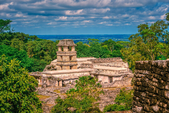 Ancient stone temple rises above lush green canopy