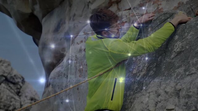 Male rock climber scaling sheer cliff, featuring technology-driven digital light points graphics