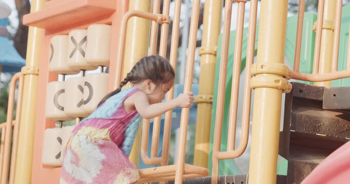 Little kindergarten girl enjoy climb on slider outdoor playground city park active learnning