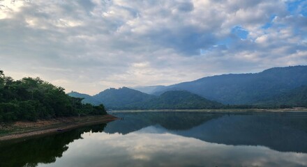 Fototapeta premium Peaceful lake landscape with mountain reflections at sunrise