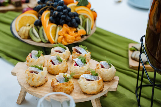 Refined Dessert Presentation Featuring Fresh Fruit And Creamy Fillings. Charming Party Setup Showcasing Miniature Tarts With Creamy Fillings And Vibrant Fruit Arrangements
