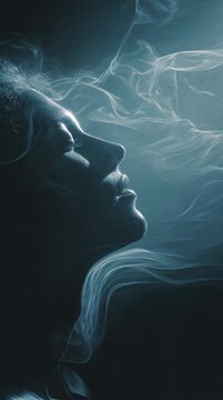 Abstract profile of a human face formed with soft flowing light and mist in a surreal composition