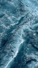 Obraz premium Close-up view of icy blue glacier with intricate cracks and textured frozen surface in cold environment