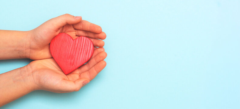 Kid holding heart shape in hand, healthcare