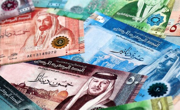 Jordanian dinar money bills pile on table. Jordan banknotes of JOD currency close up.