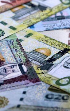 Saudi riyal money bills pile on table. Saudi Arabia banknotes of SAR currency close up.